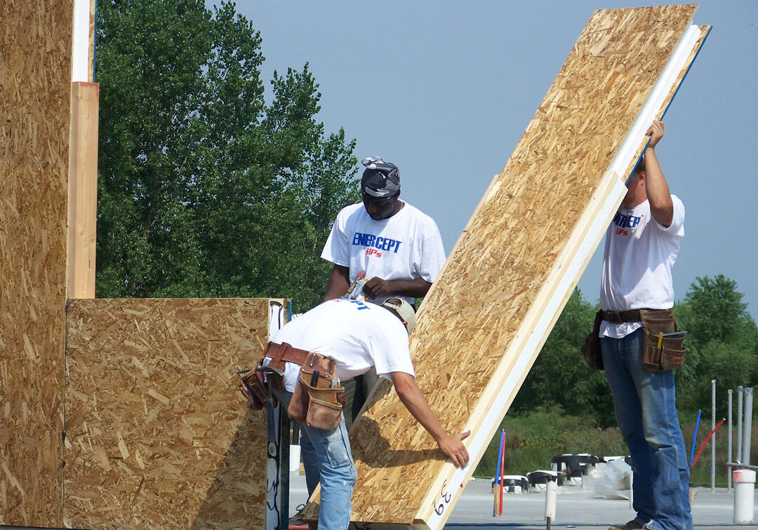 100_0078_WEB Three men applying wall panel